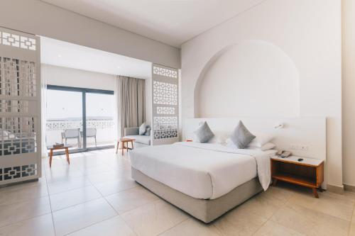 una camera con un grande letto e un soggiorno di SENTIDO Reef Oasis Suakin Resort a Marsa Alam