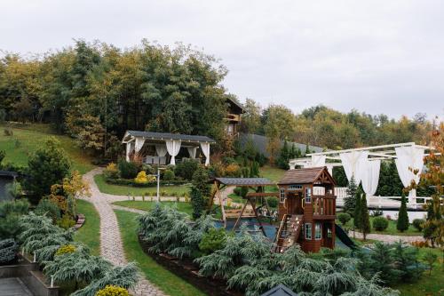 a garden with a playground and a play structure at Готель Logindariy in Rokosovo