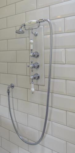 a shower with a shower head in a bathroom at Pea Cottage in Stamford