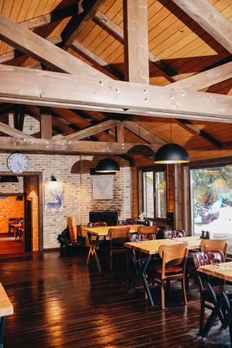 a dining room with tables and chairs in a building at Karinna Orman Evleri & Non Alcohol in Uludag