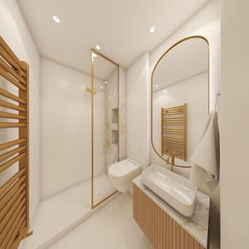 a bathroom with a sink and a mirror and a toilet at Bellevue Luxury Apartment in Paralia Dionysiou