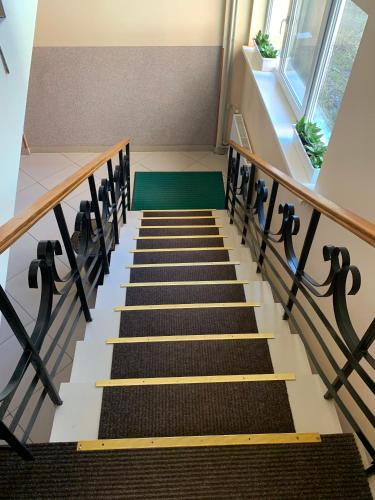 a stairway with black and white stairs and a window at Hostel Iskra in Lviv