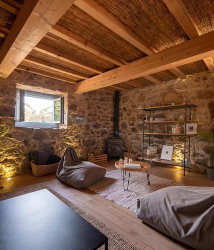 a living room with a stone wall at Doni Beach House in A Coruña