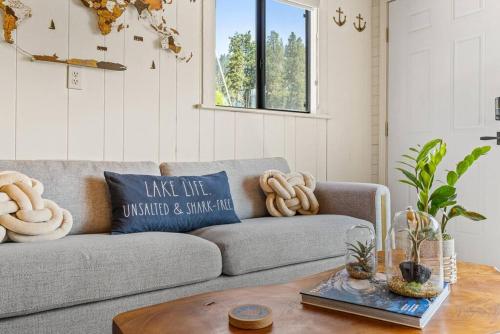 a living room with a couch and a table at Boats N Rows Float Home in Athol