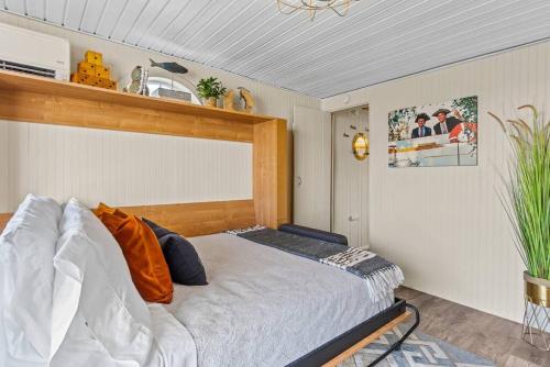 a bedroom with a bed with a wooden headboard at Boats N Rows Float Home in Athol
