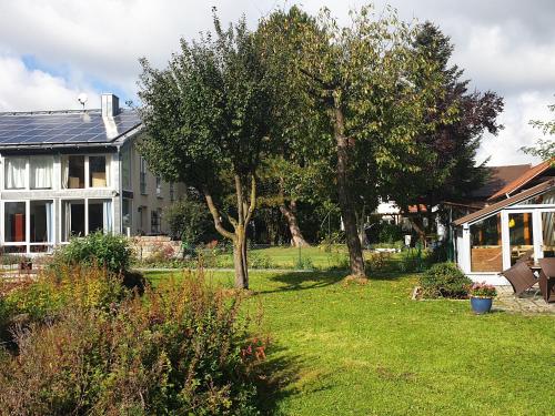 a house with a yard with trees and grass at Haus Alpenblick - b49048 in Markt Schwaben