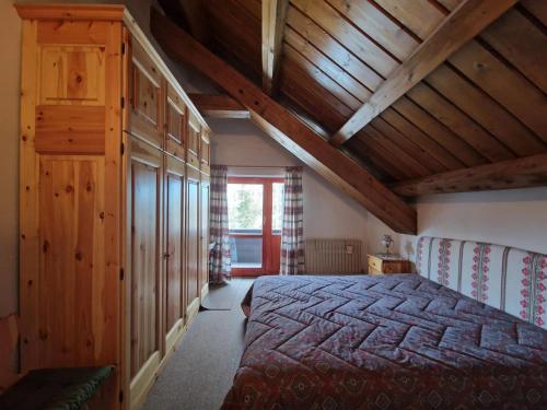 a bedroom with a bed and a wooden ceiling at Splendida Carezza in Carezza al Lago