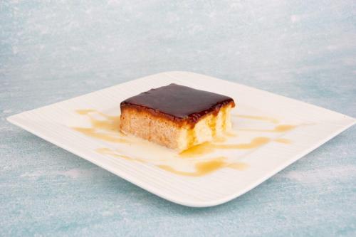 a piece of cake with chocolate on a white plate at ALYA Hotel in Barka