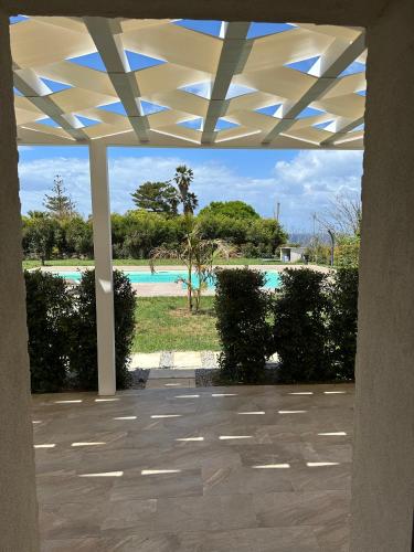 a pavilion with a view of a swimming pool at SUNSEA - Enjoy Your Family in Capo Vaticano