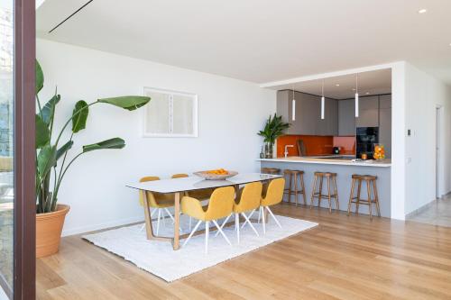 a kitchen and dining room with a table and chairs at Leiro Residences - Preferred Hotels & Resorts in Fuengirola