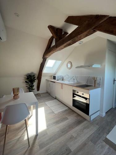 - une cuisine avec une table, une cuisinière et un comptoir dans l'établissement *CASA Mendoza*, à Cholet