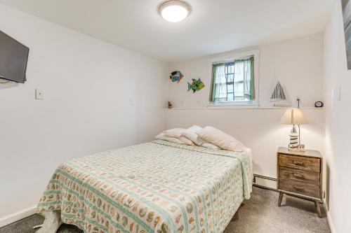 a white bedroom with a bed and a window at Milford Vacation Rental about 1 Block to Beach! in Milford