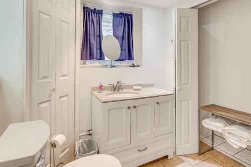 a white bathroom with a sink and a mirror at Milford Vacation Rental about 1 Block to Beach! in Milford