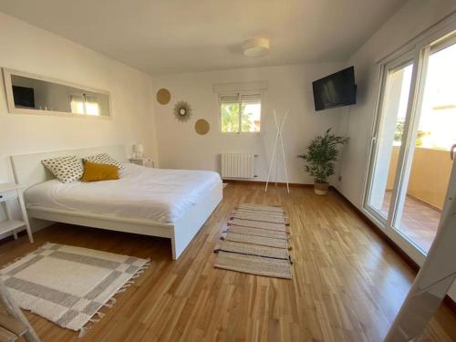 - une chambre avec un lit blanc et du parquet dans l'établissement Villa Benidorm Levante Beach, à Benidorm