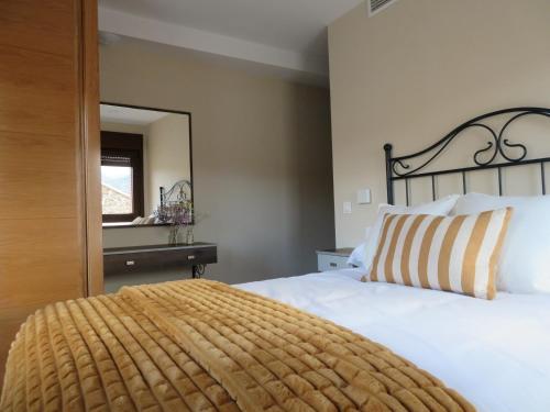 a bedroom with a large bed with a large headboard at Martín Taberna in Villavieja del Lozoya