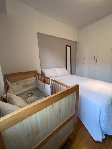 a bedroom with a large bed and a white bedvisor at Homevision - Galerius Arch Condo - City Center in Thessaloniki