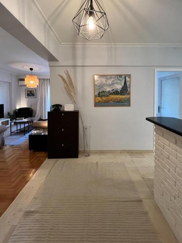 a living room with a couch and a fireplace at Homevision - Galerius Arch Condo - City Center in Thessaloniki