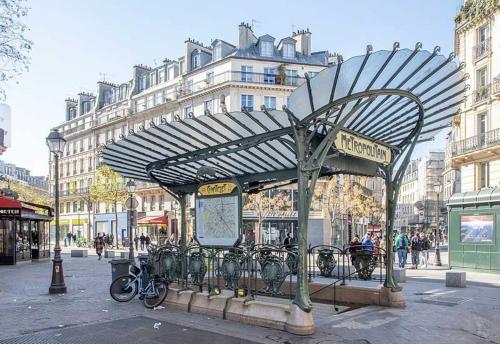 a bus stop with bicycles parked on a city street at Nice flat close to Stade de France & Paris' heart in Saint-Denis