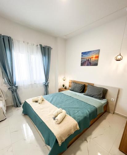 a bedroom with a large bed with towels on it at Studio by the sea Perea in Perea