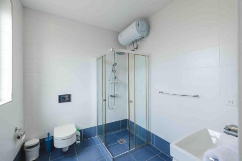 a bathroom with a glass shower and a toilet at Hidden Gem in Sliema
