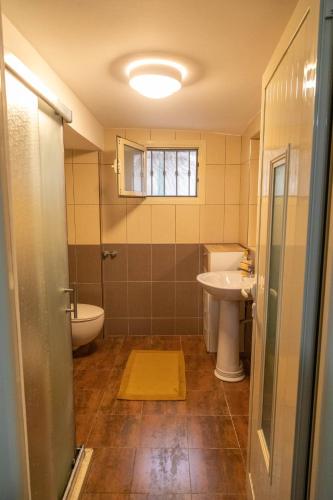 a bathroom with a sink and a toilet at Angoni Villa in Durrës