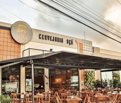 a restaurant with tables and chairs in front of it at Apartamento Farolandia in Aracaju