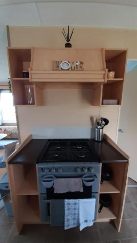 a kitchen with a stove top oven in a kitchen at The Salsa, 38 Sunset View in Crowle