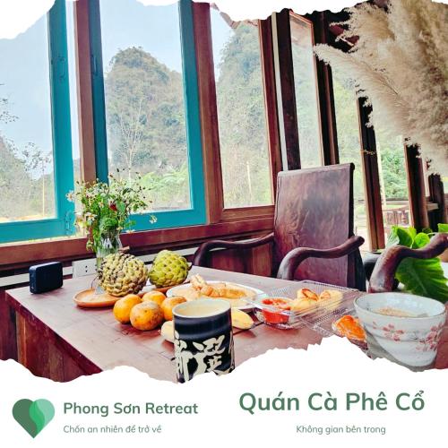a table with fruits and vegetables on it with windows at Phong Sơn Retreat - Hữu Lũng, Lạng Sơn in Lạng Sơn