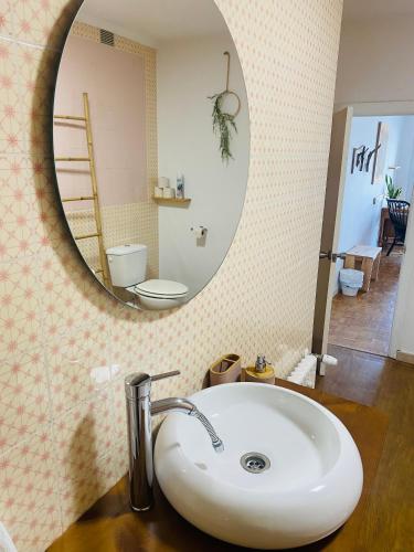 a bathroom with a sink and a mirror at Boogalow Hostel in Gijón