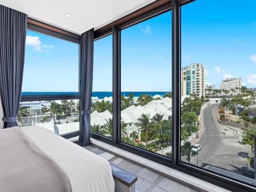 a bedroom with views of the ocean from windows at Fourteen at Mullet Bay in Cupecoy