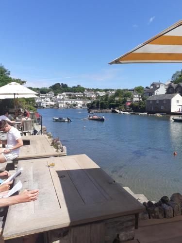 a view of a river with people sitting at a table at The Ivy Barn Holbeton in Plymouth