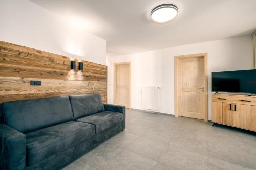 a living room with a couch and a flat screen tv at Untermoarhof Albeins in Bressanone