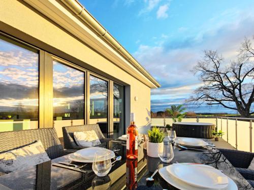a dining table with a view of the ocean at Luxus-Penthouse mit Whirlpool bei Hannover in Burgwedel