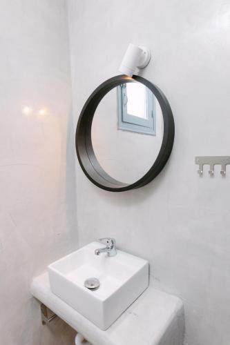 a bathroom with a white sink and a mirror at Seven Grapes - Karterados in Karterados