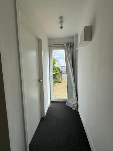an empty hallway with an open door to a room at Studio flat, parking, Filton in Bristol
