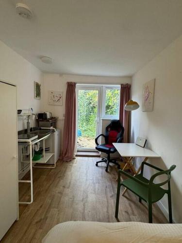 a room with a kitchen with a table and chairs at Studio flat, parking, Filton in Bristol