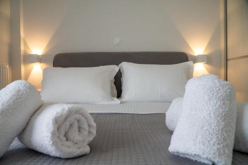a bedroom with a bed with white towels and pillows at Central apartment near to Acropolis area in Athens