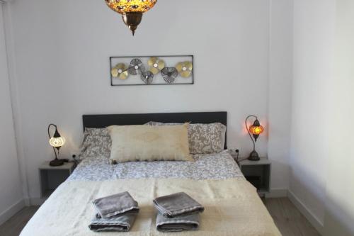 a bedroom with a bed with two pillows on it at Apartamentos Vado - Arco de Elvira in Granada