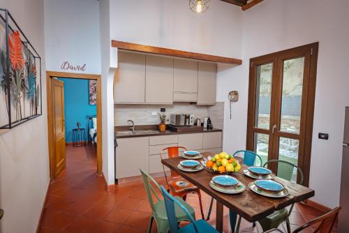 a kitchen with a table with a bowl of fruit on it at Florence Garden Suite in Florence
