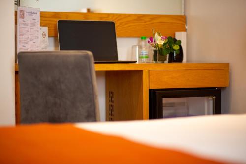 a desk with a laptop computer on top of it at Le Pietri Urban Hotel in Rabat
