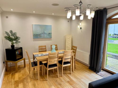 a dining room with a table and chairs at 3 Castle Hume Court Holiday House in Enniskillen
