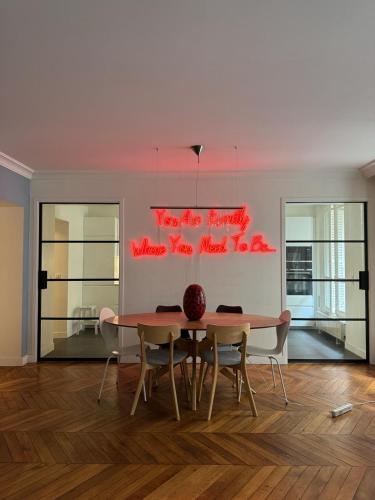 a dining room with a table and chairs at No Matter Stay - Chic and classy - Arc de Triomphe in Paris