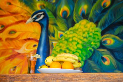 a plate of fruit with bananas and oranges on a table at Imanje Lotus Garden in Šabac