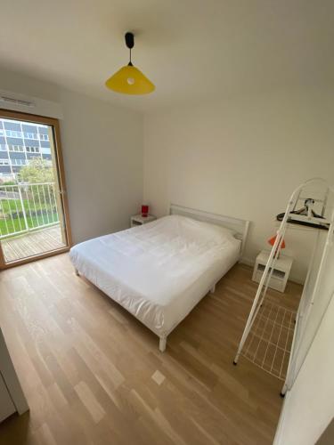 a bedroom with a white bed and a ladder at Appartement Confort Velizy in Vélizy-Villacoublay