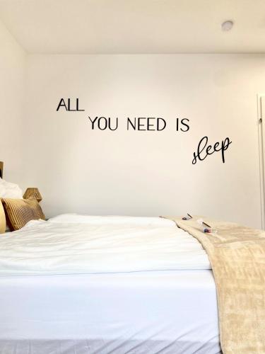 a bedroom with a bed with the words all you need is sleep at Skyview Residence - Self Check In - Near City Centre in Graz