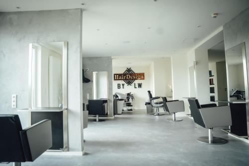 a hair salon with chairs and a sign on the wall at nordica Hotel Friesenhof in Büsum