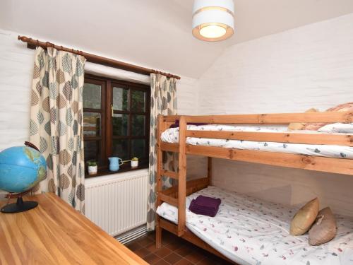 a room with two bunk beds and a desk at 2 Bed in Cilgerran FB173 in Cilgerran