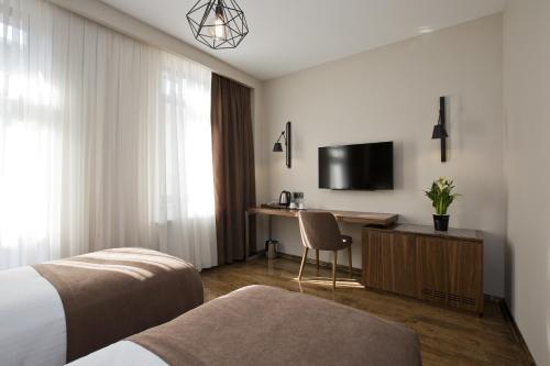 Postel nebo postele na pokoji v ubytování Snog Rooms & Suites