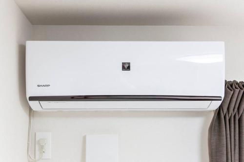 a white stove top oven in a room at Logement Aile 102 in Takasaki