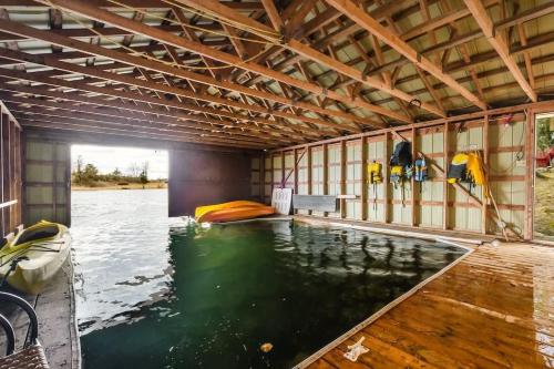 a large indoor pool of water in a building at Private waterfront cottage - hot tub & kayaks in Kingston